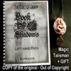 A spiral-bound book titled 'Book Of Shadows' is displayed next to a pendant necklace, accompanied by text overlays reading 'Magic Talisman + GIFT'.